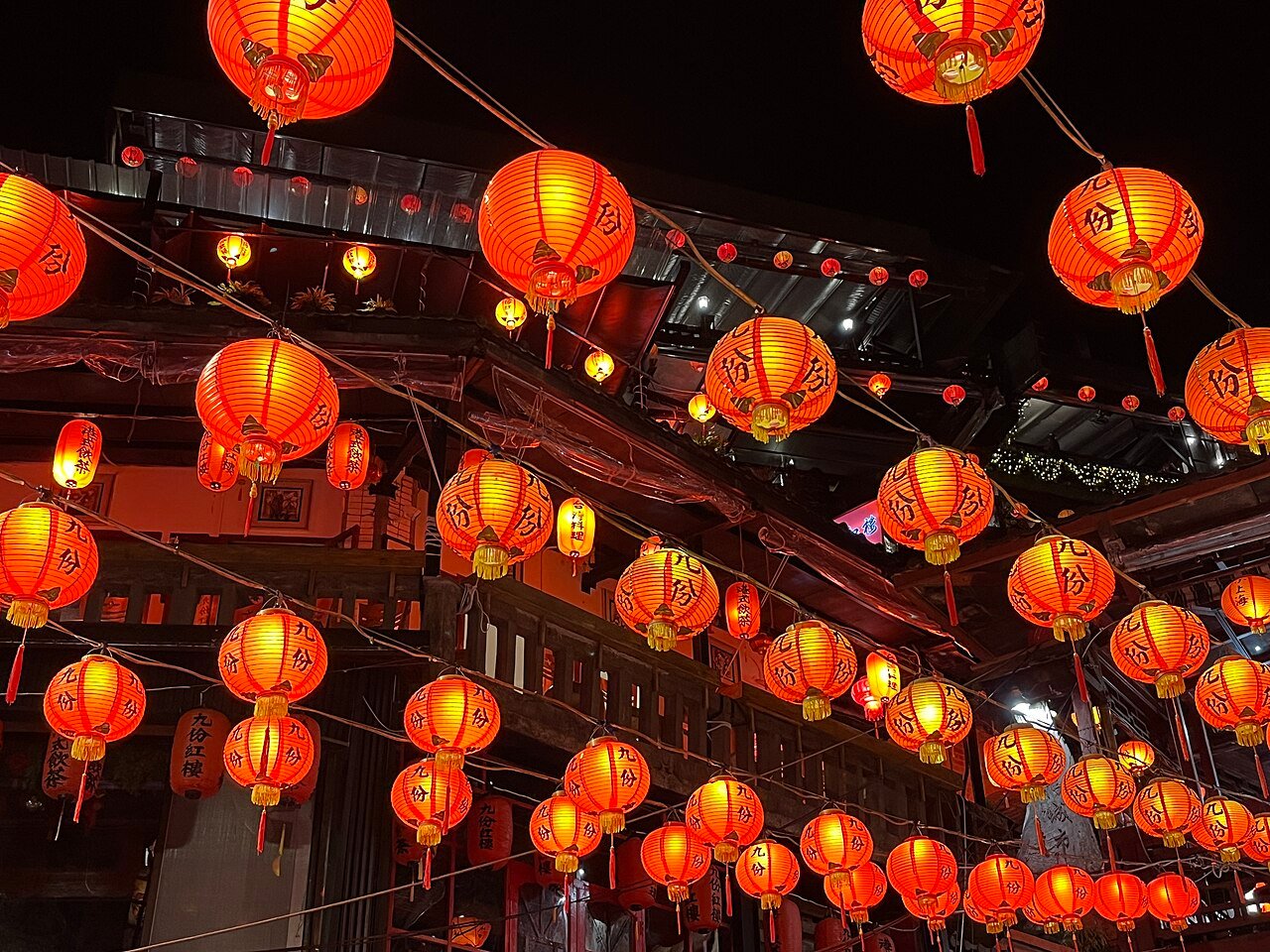 Rows of glowing red lanterns over Jiufen Old Street at night