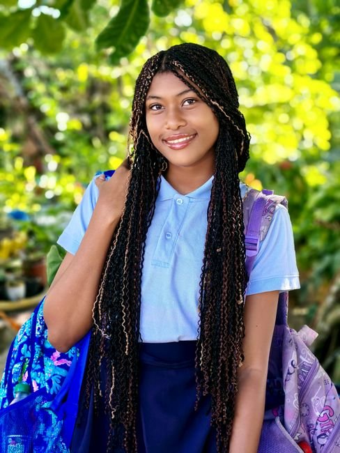 A smiling teenage student with a backpack